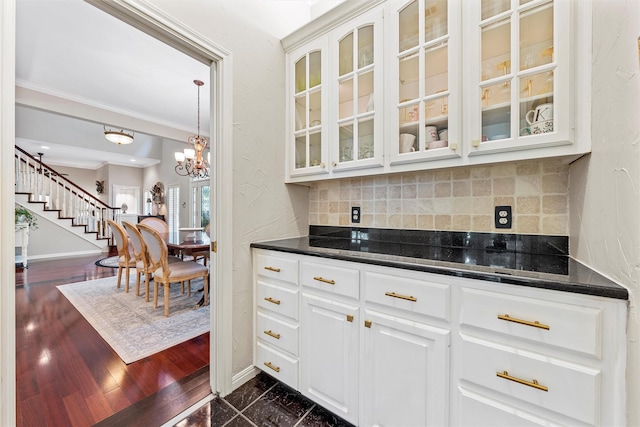 146 Shady Trl, Waco, TX 76657 - bar with crown molding, decorative backsplash, baseboards, stairs, and a chandelier