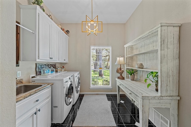146 Shady Trl, Waco, TX 76657 - washroom with cabinet space, washing machine and clothes dryer, a chandelier, and baseboards