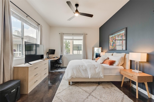 3025 Bryan St Unit 1F, Dallas, TX 75204 - bedroom with an office area, ceiling fan, and dark wood-style flooring