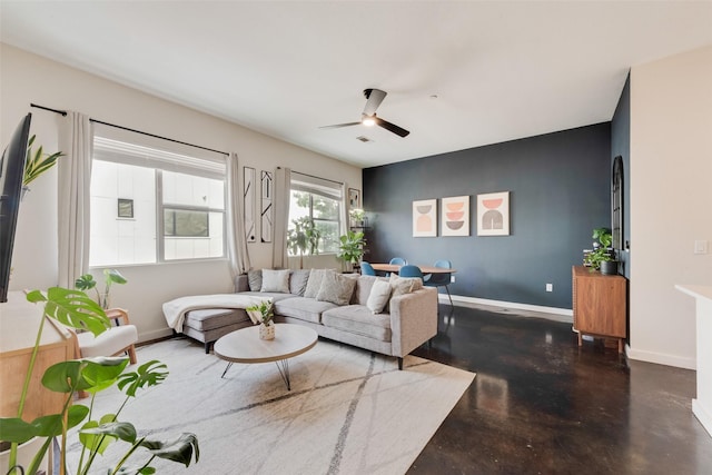 3025 Bryan St Unit 1F, Dallas, TX 75204 - living room featuring finished concrete floors, ceiling fan, and baseboards