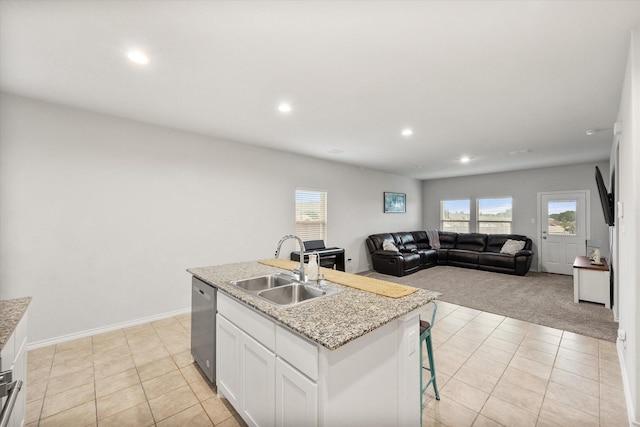 105 Greengate Dr, Boyd, TX 76023 - kitchen with recessed lighting, dishwasher, white cabinetry, light colored carpet, and a kitchen island with sink