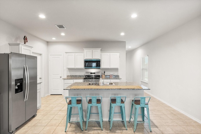 105 Greengate Dr, Boyd, TX 76023 - kitchen with stainless steel appliances, recessed lighting, light tile patterned floors, and white cabinets