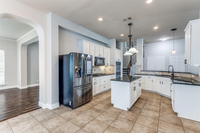 13274 Bayfield Dr, Frisco, TX 75033 - kitchen featuring stainless steel fridge, black microwave, backsplash, a sink, and a center island