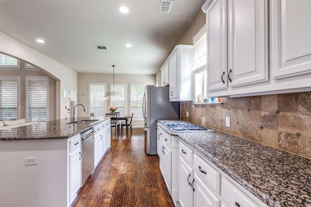 15630 Stonebridge Dr, Frisco, TX 75035 - kitchen featuring a sink, stainless steel appliances, a kitchen island with sink, dark wood finished floors, and white cabinetry