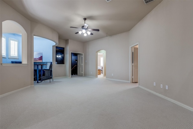 15630 Stonebridge Dr, Frisco, TX 75035 - unfurnished living room with arched walkways, a ceiling fan, carpet, and baseboards