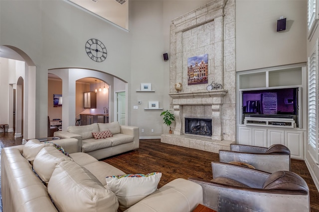 15630 Stonebridge Dr, Frisco, TX 75035 - living room with a towering ceiling, wood finished floors, baseboards, and a large fireplace