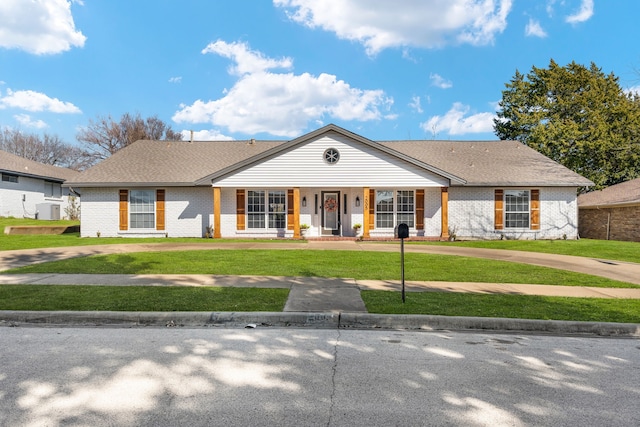 2005 Westshore Dr, Garland, TX 75043 - view of front of home featuring brick siding, curved driveway, and a porch
