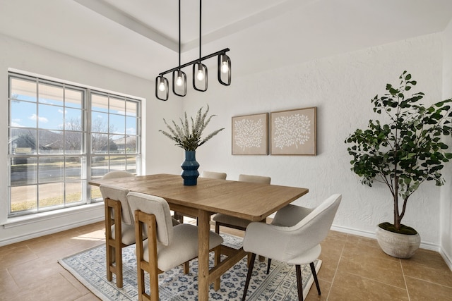 2005 Westshore Dr, Garland, TX 75043 - dining space featuring tile patterned floors, baseboards, a textured wall, and a chandelier