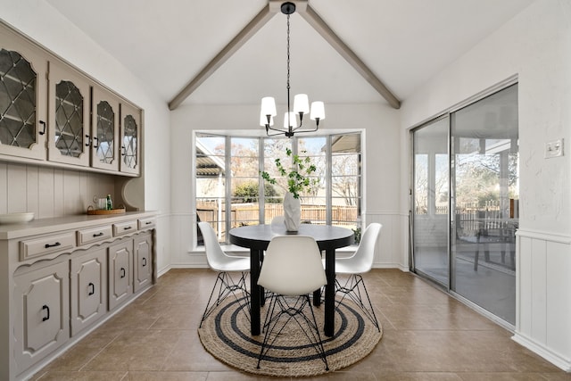 2005 Westshore Dr, Garland, TX 75043 - tiled dining space with a chandelier, a wainscoted wall, and a decorative wall