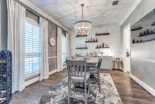 2758 Sharlis Dr, Frisco, TX 75036 - dining space with bar, crown molding, a chandelier, baseboards, and dark wood-type flooring