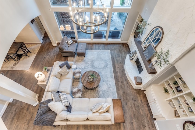 2758 Sharlis Dr, Frisco, TX 75036 - living area featuring wood finished floors, a high ceiling, a chandelier, and baseboards