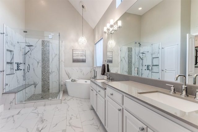 2758 Sharlis Dr, Frisco, TX 75036 - bathroom featuring a marble finish shower, double vanity, marble finish flooring, a soaking tub, and a chandelier