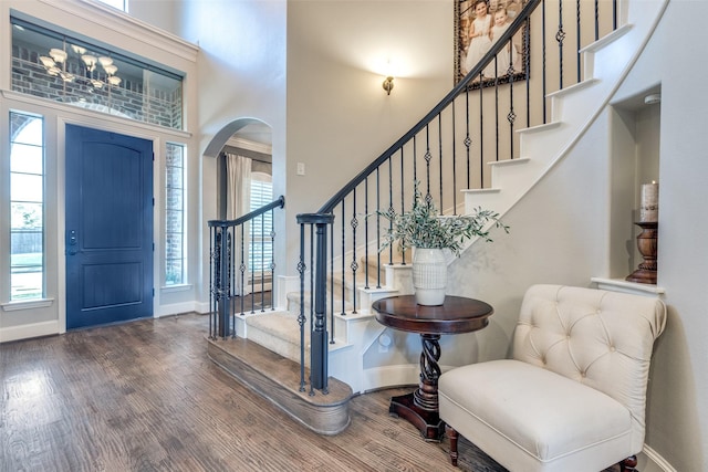 2758 Sharlis Dr, Frisco, TX 75036 - entryway featuring wood finished floors, arched walkways, baseboards, and a towering ceiling