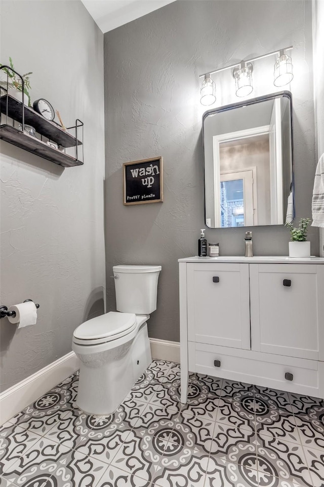 2758 Sharlis Dr, Frisco, TX 75036 - bathroom with toilet, vanity, baseboards, and tile patterned floors