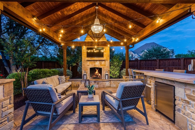 2758 Sharlis Dr, Frisco, TX 75036 - fenced backyard featuring a patio area, a gazebo, and an outdoor living space with a fireplace