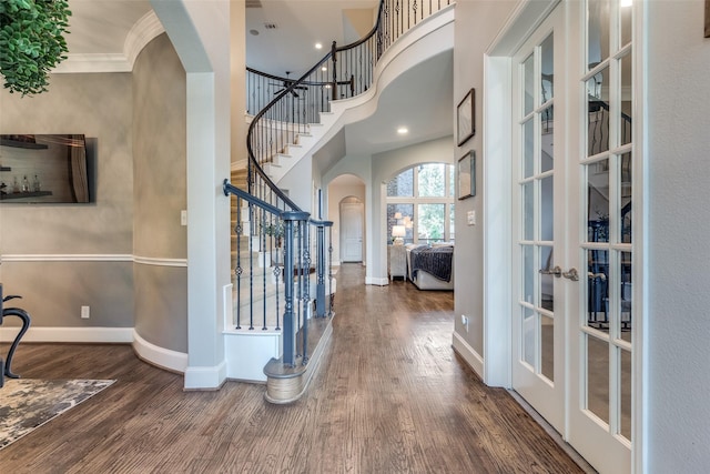 2758 Sharlis Dr, Frisco, TX 75036 - foyer with arched walkways, stairway, wood finished floors, french doors, and crown molding