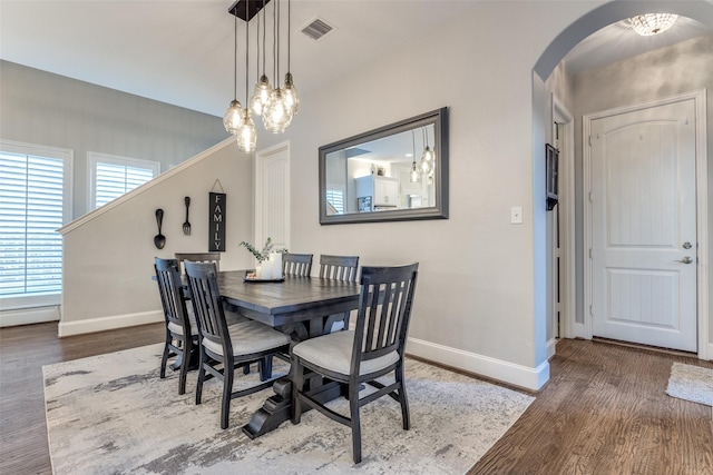 2758 Sharlis Dr, Frisco, TX 75036 - dining room with arched walkways, baseboards, wood finished floors, and a chandelier