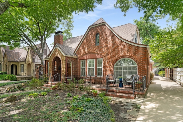 6843 Casa Loma Ave, Dallas, TX 75214 - english style home with brick siding, roof with shingles, and a chimney