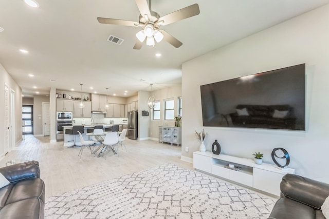 6313 Hedgecoxe Rd, The Colony, TX 75056 - living room featuring ceiling fan, recessed lighting, light wood-type flooring, and baseboards