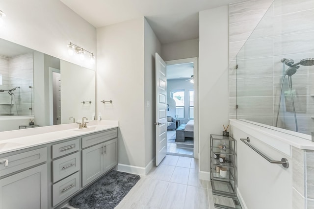 6313 Hedgecoxe Rd, The Colony, TX 75056 - bathroom featuring double vanity, ensuite bath, tiled shower, ceiling fan, and baseboards
