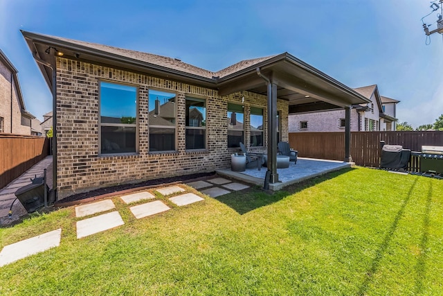 6313 Hedgecoxe Rd, The Colony, TX 75056 - back of house featuring brick siding and a patio