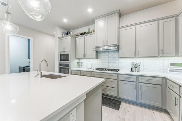 6313 Hedgecoxe Rd, The Colony, TX 75056 - kitchen featuring stainless steel appliances, gray cabinets, a sink, light countertops, and recessed lighting