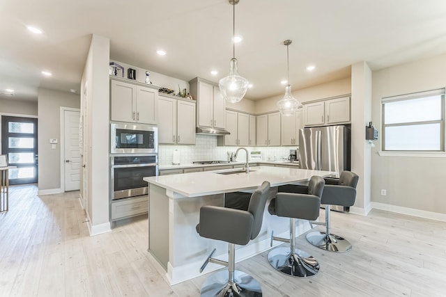 6313 Hedgecoxe Rd, The Colony, TX 75056 - kitchen featuring appliances with stainless steel finishes, a sink, decorative backsplash, plenty of natural light, and recessed lighting