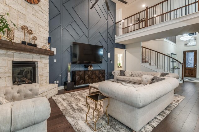 1405 Thunder Dove Dr, Mansfield, TX 76084 - living area featuring stairway, a high ceiling, hardwood / wood-style floors, a fireplace, and baseboards