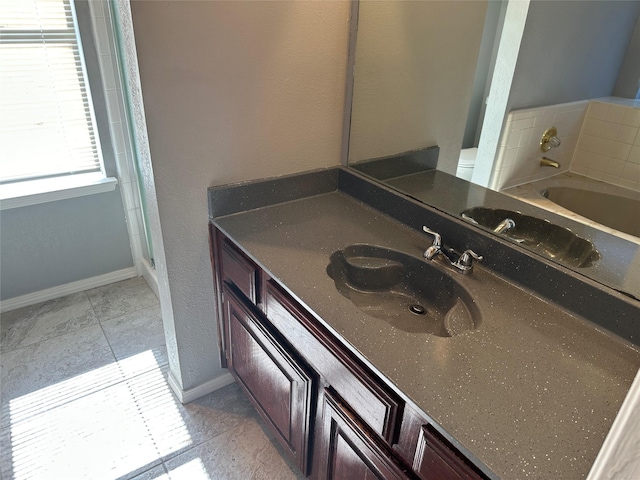 1512 Straus Rd, Cedar Hill, TX 75104 - bathroom featuring vanity, a bath, baseboards, and tile patterned flooring