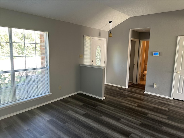 1512 Straus Rd, Cedar Hill, TX 75104 - unfurnished dining area with dark wood-style flooring, lofted ceiling, and baseboards