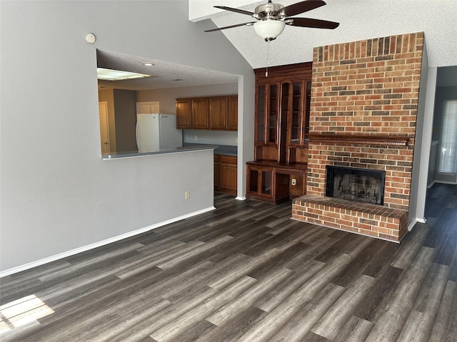 1512 Straus Rd, Cedar Hill, TX 75104 - unfurnished living room with ceiling fan, dark wood finished floors, lofted ceiling, a brick fireplace, and baseboards
