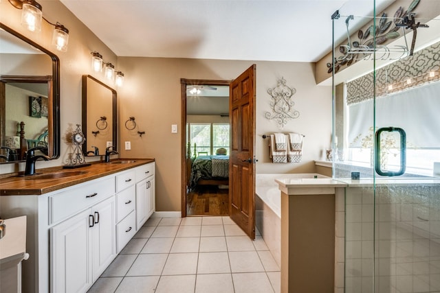 140 Daisey Ln, Justin, TX 76247 - bathroom with double vanity, a garden tub, tile patterned floors, ensuite bathroom, and ceiling fan