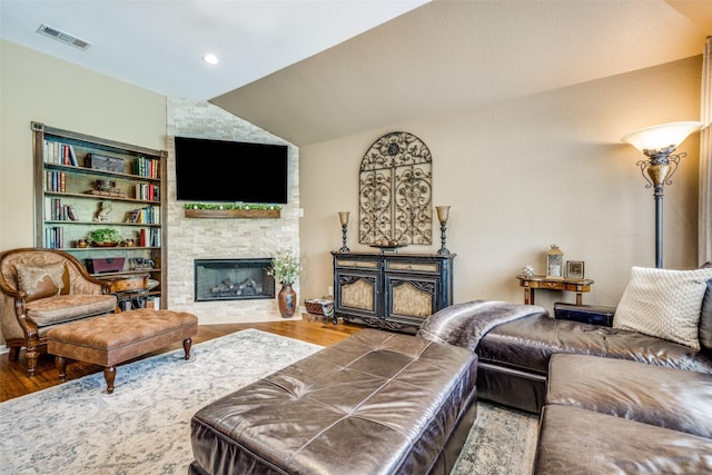 140 Daisey Ln, Justin, TX 76247 - living area featuring wood finished floors, a stone fireplace, and vaulted ceiling