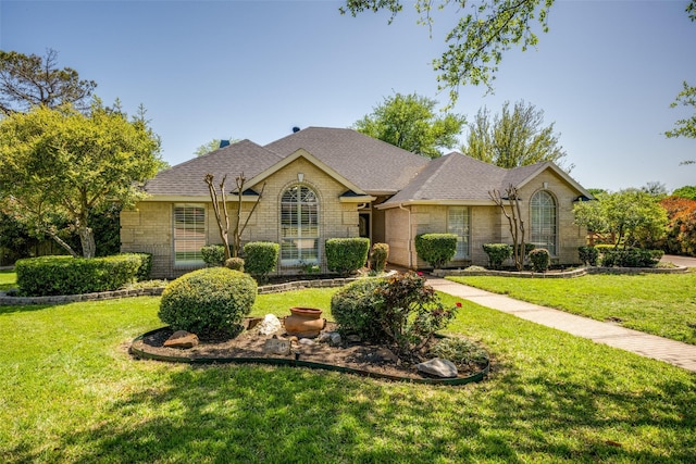 140 Daisey Ln, Justin, TX 76247 - view of front of house featuring a front lawn, brick siding, and a shingled roof