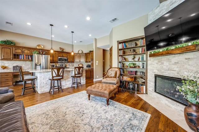 140 Daisey Ln, Justin, TX 76247 - living area with wood finished floors, a stone fireplace, and recessed lighting