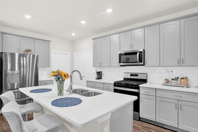 4925 Westhill Dr, Princeton, TX 75071 - kitchen featuring stainless steel appliances, gray cabinets, a sink, an island with sink, and recessed lighting