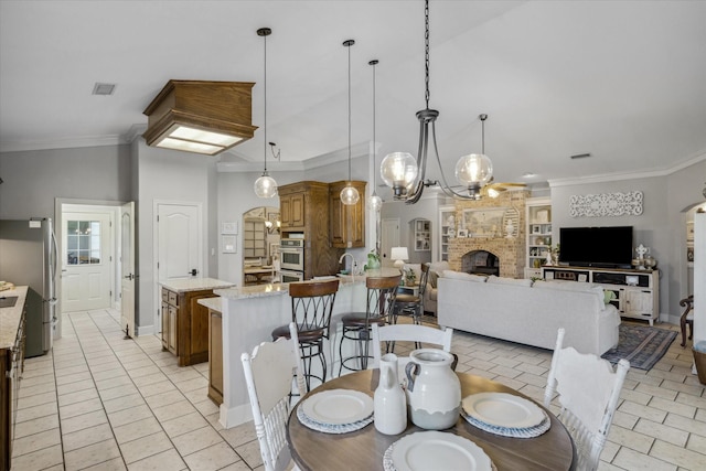 552 Heritage Ct, Canton, TX 75103 - dining area featuring a brick fireplace, ornamental molding, baseboards, and a chandelier