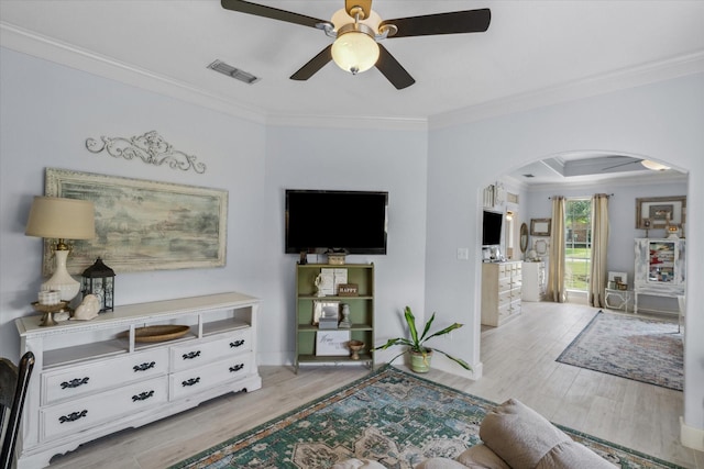 552 Heritage Ct, Canton, TX 75103 - living area with arched walkways, crown molding, wood finished floors, a ceiling fan, and baseboards