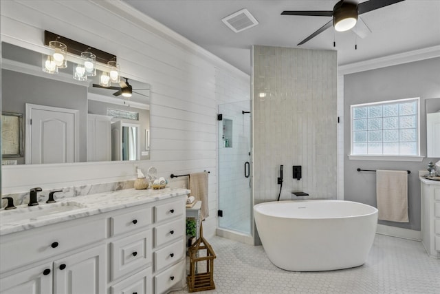 552 Heritage Ct, Canton, TX 75103 - bathroom with ceiling fan, vanity, a stall shower, a freestanding bath, and ornamental molding