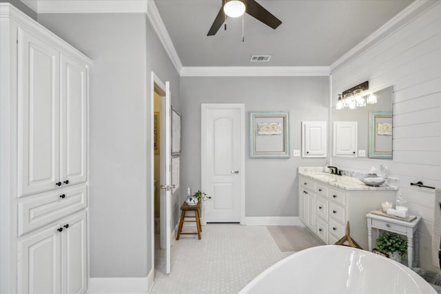 552 Heritage Ct, Canton, TX 75103 - bathroom with a freestanding tub, crown molding, double vanity, baseboards, and a ceiling fan