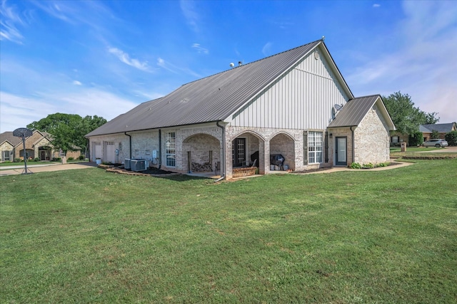 552 Heritage Ct, Canton, TX 75103 - back of property with cooling unit, concrete driveway, a lawn, and metal roof