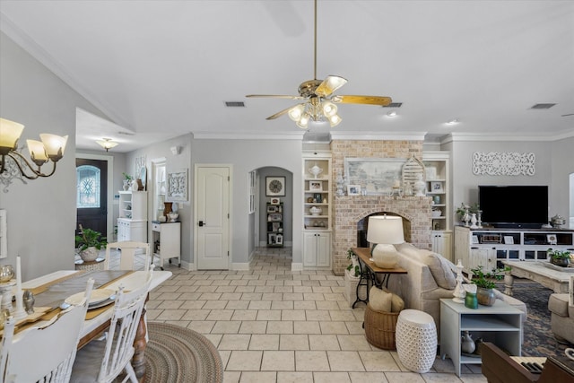 552 Heritage Ct, Canton, TX 75103 - living area with ceiling fan, built in features, baseboards, arched walkways, and a brick fireplace