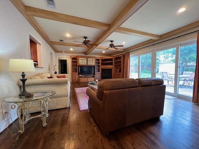1509 W Hull St, Denison, TX 75020 - living room featuring coffered ceiling, dark wood-type flooring, a ceiling fan, beamed ceiling, and a fireplace