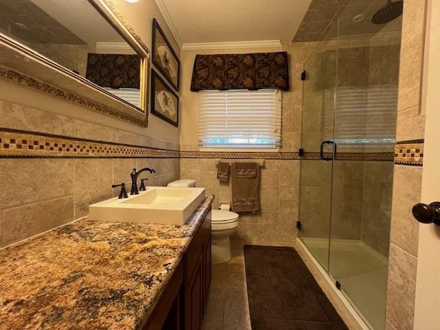 1509 W Hull St, Denison, TX 75020 - bathroom featuring a stall shower, vanity, ornamental molding, toilet, and tile walls