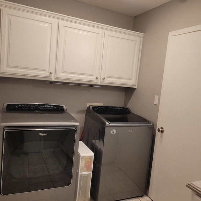 1509 W Hull St, Denison, TX 75020 - laundry room featuring washing machine and dryer, cabinet space, and light tile patterned floors