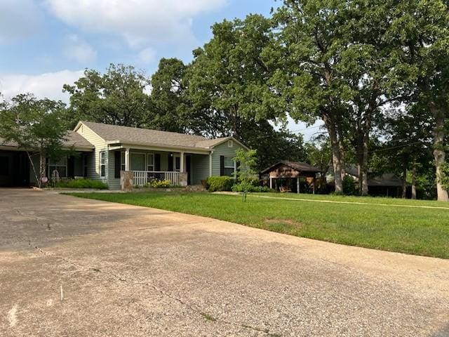 1509 W Hull St, Denison, TX 75020 - ranch-style home featuring a porch, a front yard, and driveway