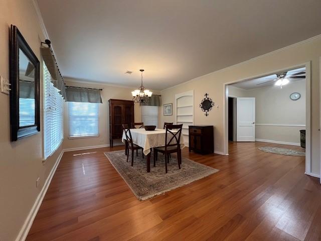 1509 W Hull St, Denison, TX 75020 - dining area with a chandelier, wood finished floors, ornamental molding, baseboards, and a ceiling fan
