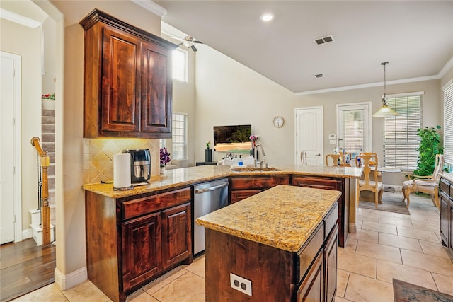 1001 Vineyard Dr, Euless, TX 76039 - kitchen featuring stainless steel dishwasher, a sink, a peninsula, ornamental molding, and light stone counters