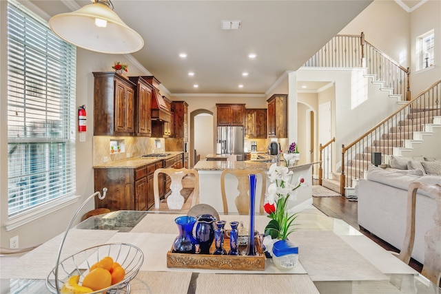1001 Vineyard Dr, Euless, TX 76039 - kitchen featuring arched walkways, stainless steel appliances, light stone counters, ornamental molding, and recessed lighting