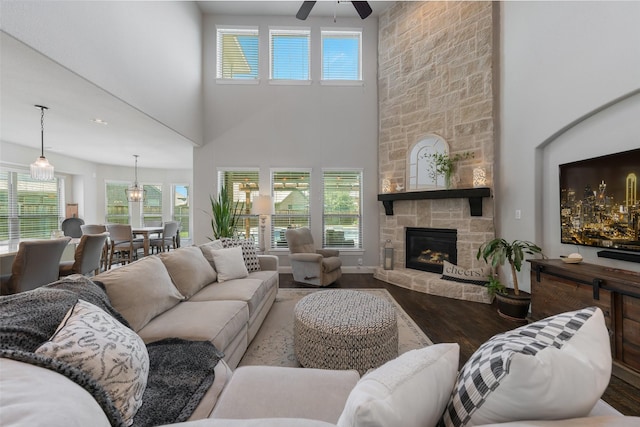 760 Ascot Ct, Prosper, TX 75078 - living area with wood finished floors, a ceiling fan, a towering ceiling, plenty of natural light, and a stone fireplace
